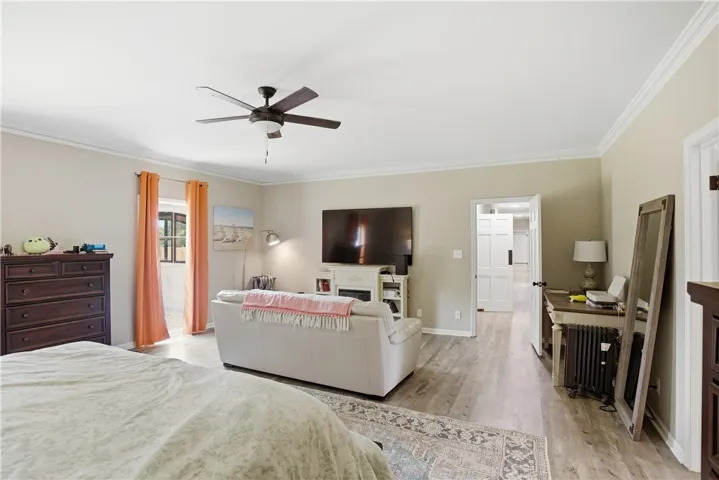 Comfortable living area with recessed lighting and warm wood flooring.