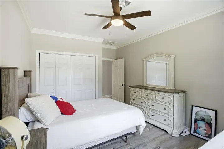 An inviting sleeping space with clean lines and light-toned flooring.