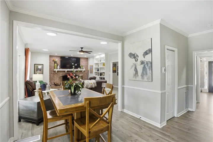 An inviting open floorplan provides a seamless transition from dining to the cozy living area.