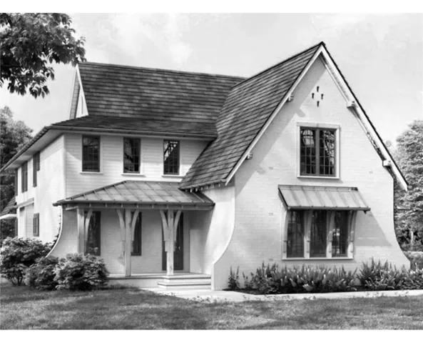 Timeless charm defines this residence, featuring a welcoming covered porch and an inviting architectural silhouette.