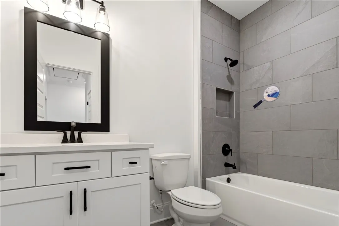 A well-appointed bathroom features sleek tile work, a modern vanity, and contemporary fixtures.