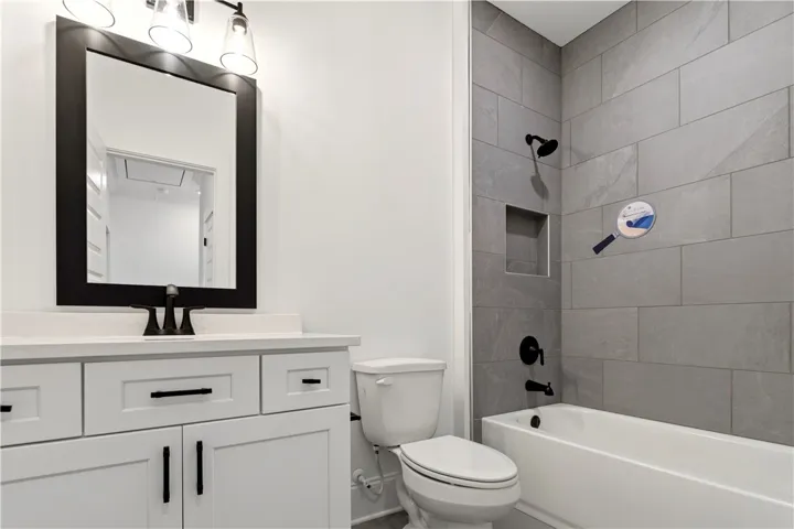 A well-appointed bathroom features sleek tile work, a modern vanity, and contemporary fixtures.