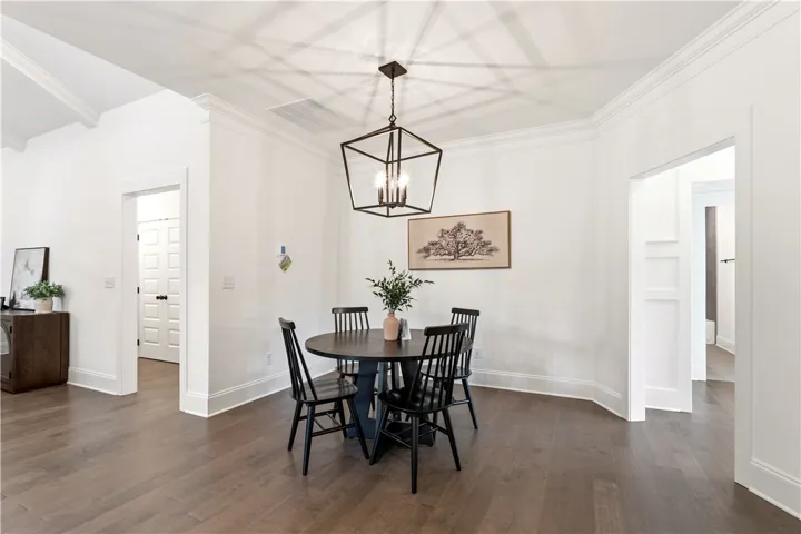 Hardwood floors and crisp white trim create an inviting atmosphere in this flexible dining space.