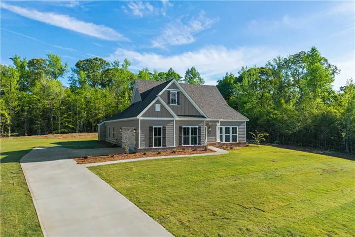 A well-maintained lawn and extended driveway enhance this attractive residence's curb appeal.