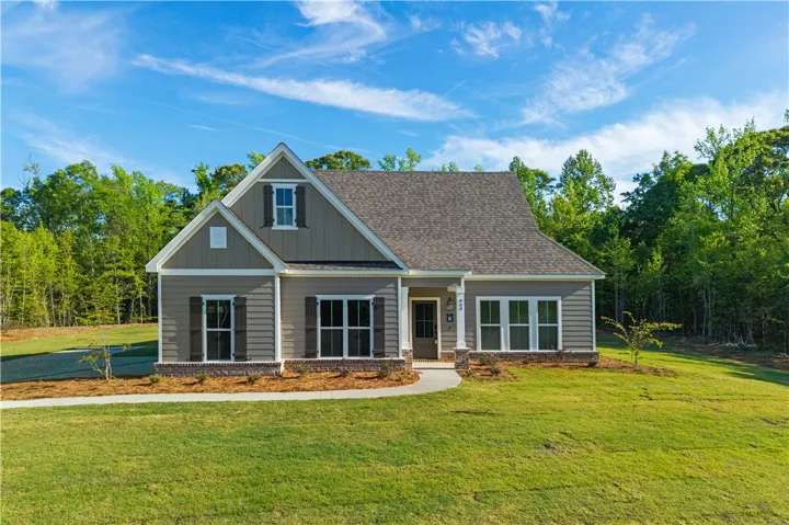 A charming single-family residence with inviting curb appeal, set against a backdrop of mature trees.