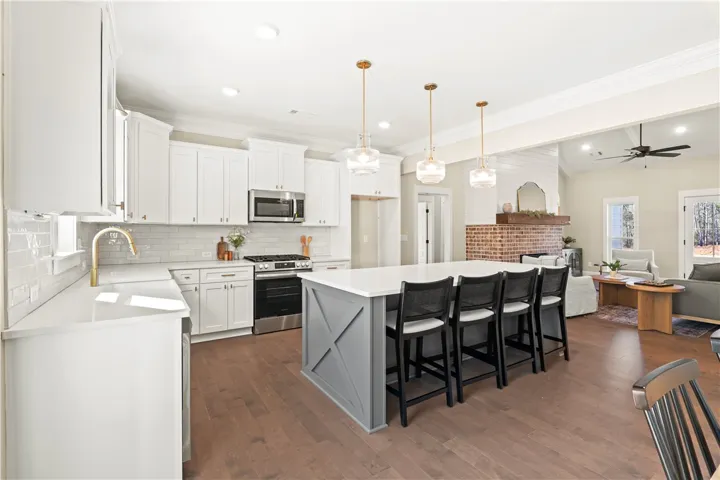 Culinary dreams come to life in this open-concept kitchen, seamlessly flowing into a cozy living space.