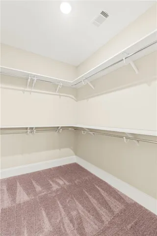 Ample shelving and hanging space defines this organized, ready-to-use closet.