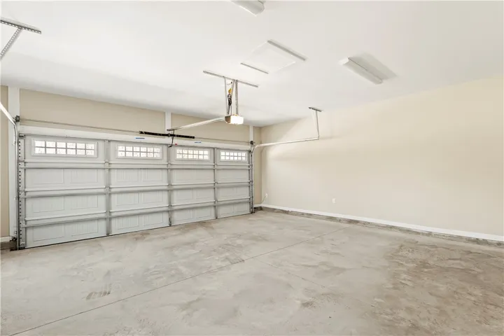 An immaculate garage offers ample space and a pristine concrete floor, ready for vehicles or projects.