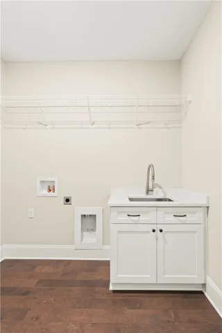 Functional utility room with ample storage and a convenient sink.
