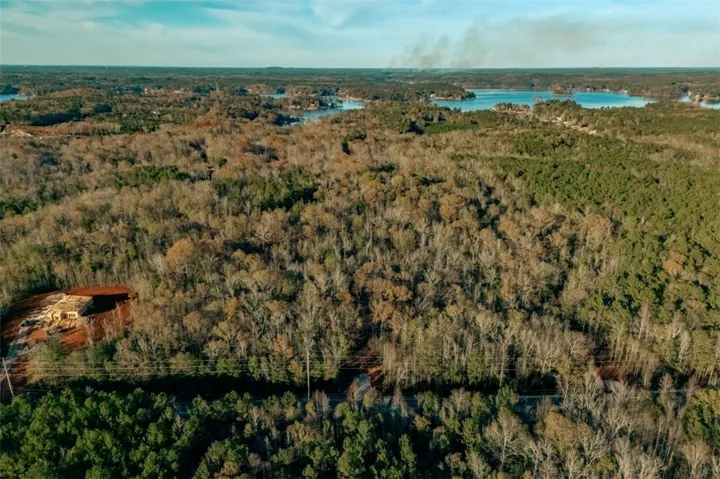 A tranquil lake view from a wooded lot, ideal for building a custom retreat.