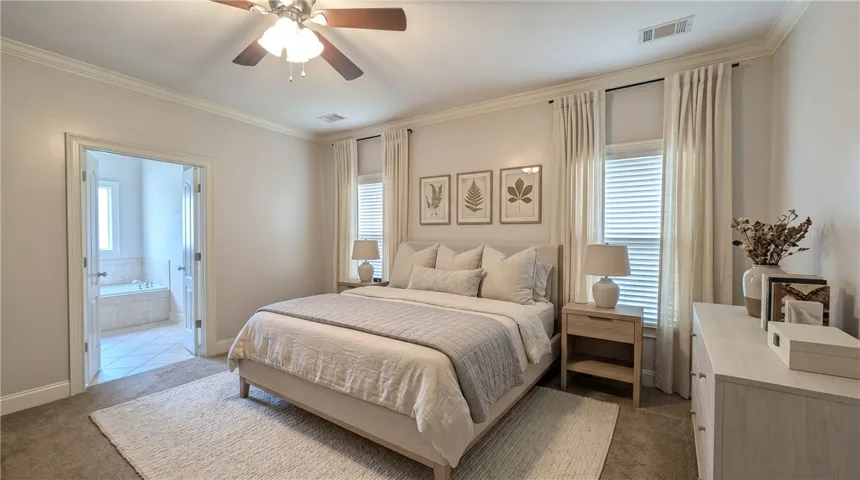(DIGITALLY STAGED) Tranquil main-level primary suite.