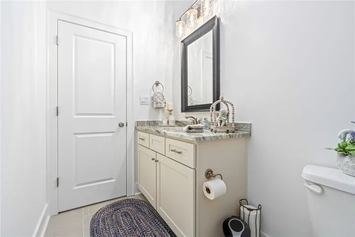 A well-appointed bathroom vanity with elegant granite counters and classic fixtures.