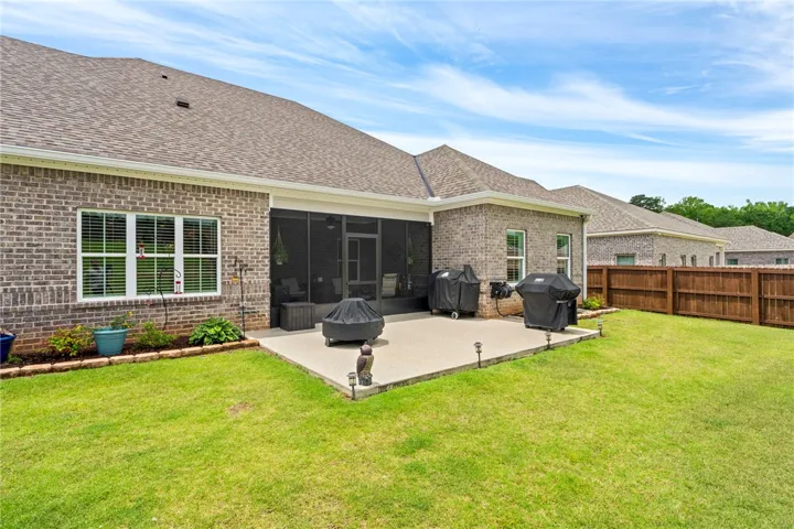 A spacious backyard with a patio provides an excellent setting for outdoor gatherings and entertainment.