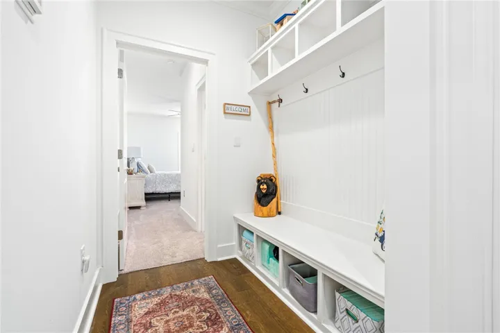 A built-in bench with cubby storage and coat hooks provides a functional entry.