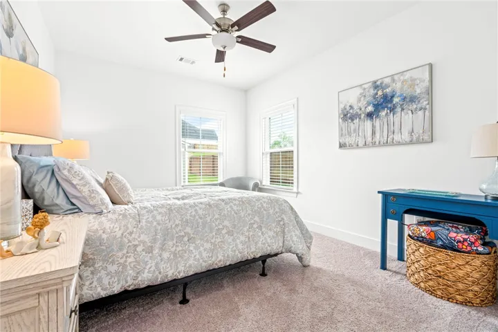 Two windows bathe this peaceful sleeping space in natural illumination, creating a serene ambiance.