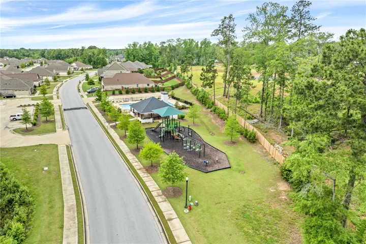 A vibrant playground and sparkling pool await within this welcoming community setting.