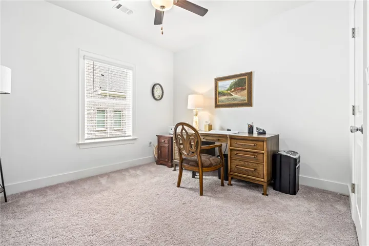 A well-lit room offering a quiet space for productivity or relaxation.