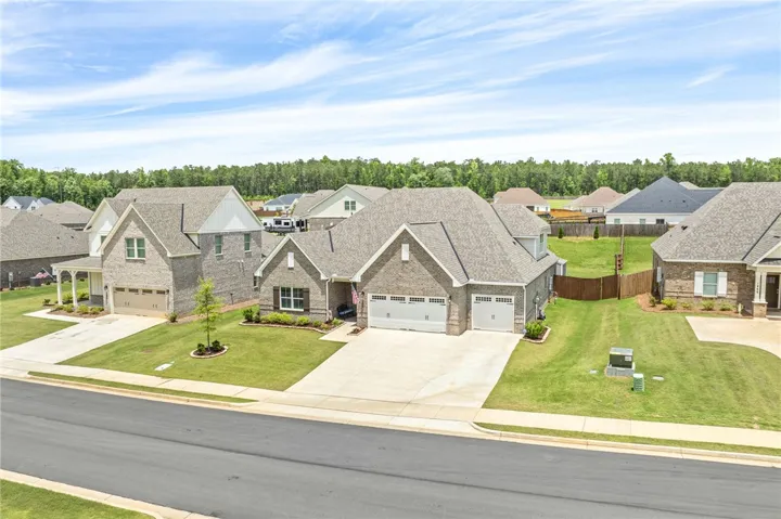 A classic brick exterior graces this residential property with a well-maintained yard and concrete driveway.