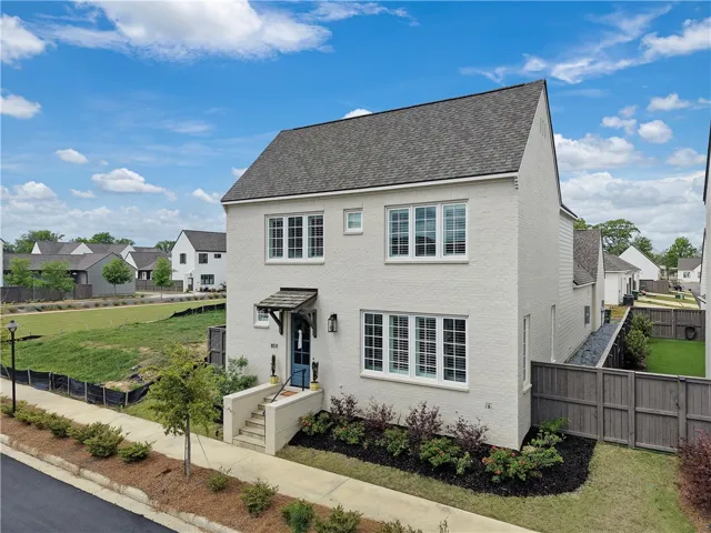 A striking contemporary facade with classic windows, beckons from a well-kept neighborhood.