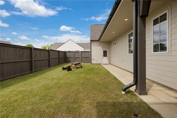 An enclosed yard with verdant grass offers private outdoor enjoyment.