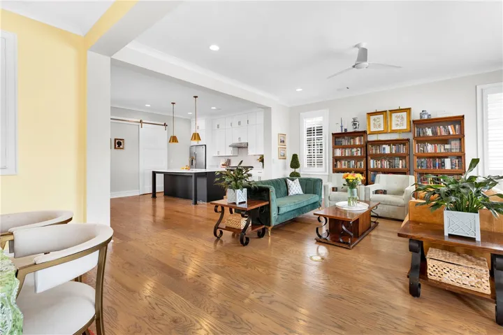 Hardwood floors stretch across this inviting open-concept living space, blending comfort with contemporary style.