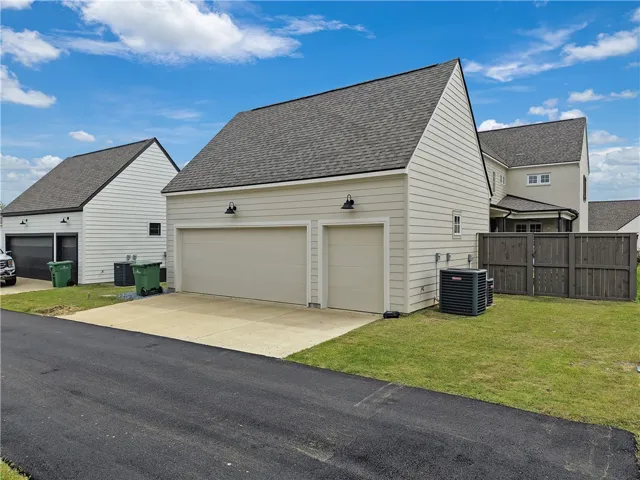 A detached garage with dual doors offers convenient vehicle storage and ample space for projects.