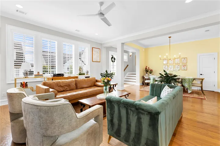 Sun-filled interiors welcome you into this living area with lustrous hardwood flooring and an elegant dining space.