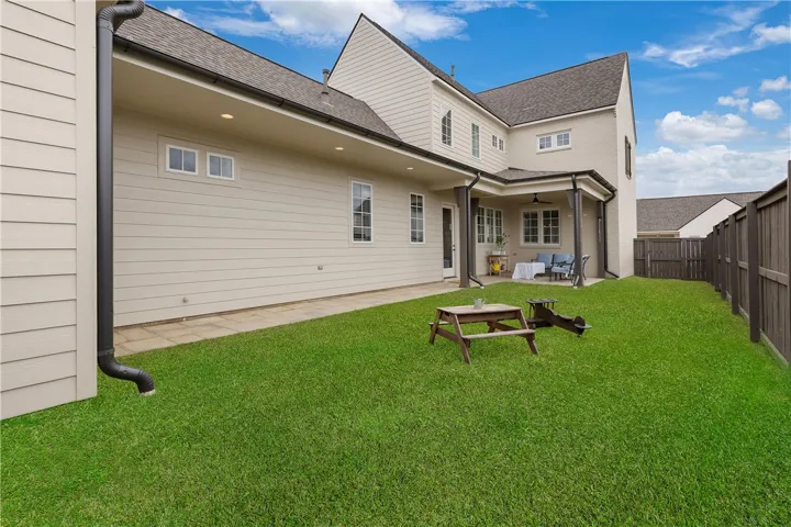 A generous lawn and covered patio provide ample outdoor living space.