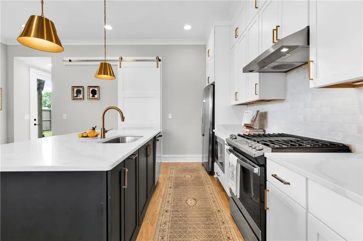 A well-appointed kitchen showcasing a spacious island with sink and modern appliances.