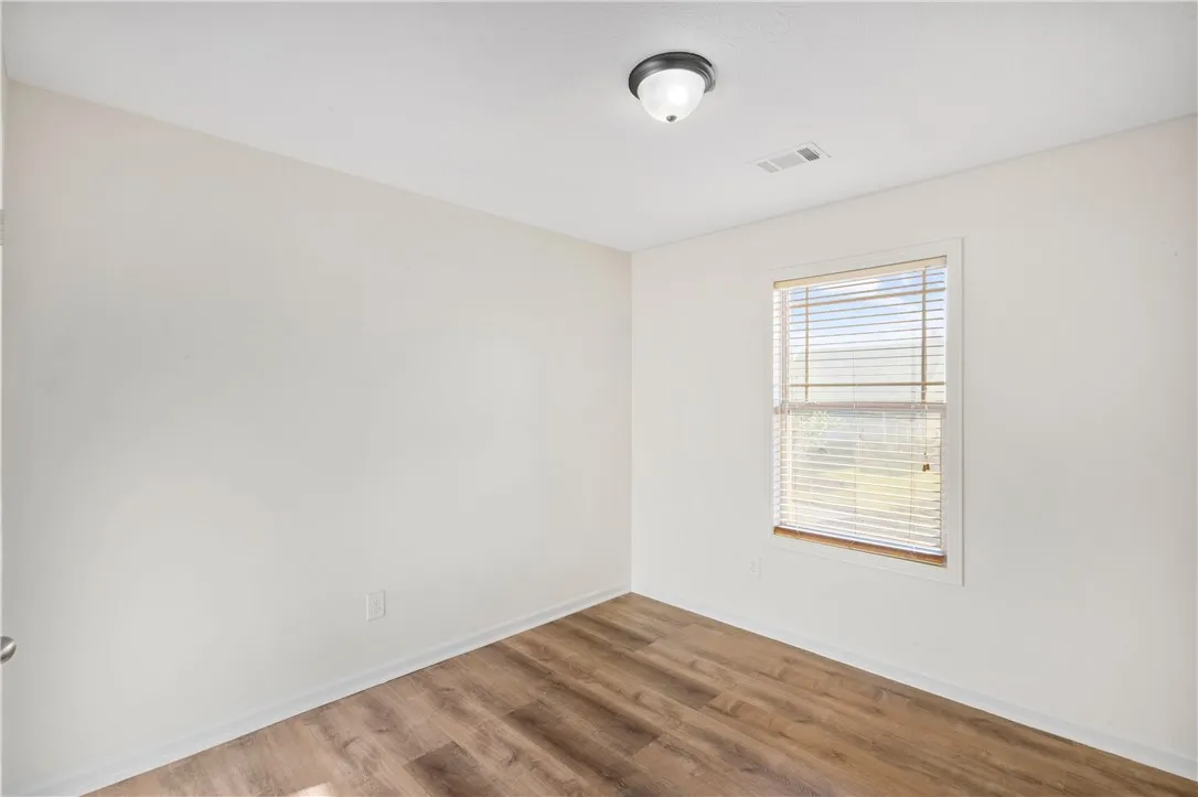 This spacious bedroom offers ample natural light and LVP flooring, ideal for a comfortable lifestyle.