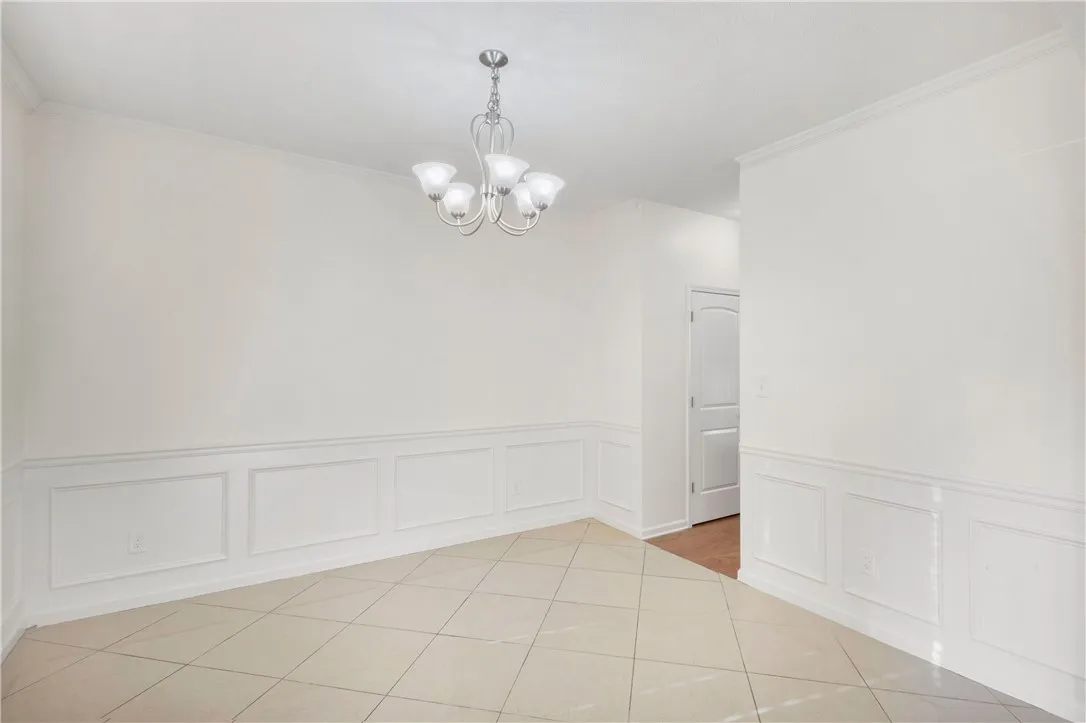This bright room features tile flooring and detailed wall paneling.