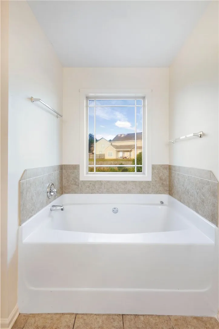 Relax and unwind in this spacious bathtub, perfect for a tranquil escape.