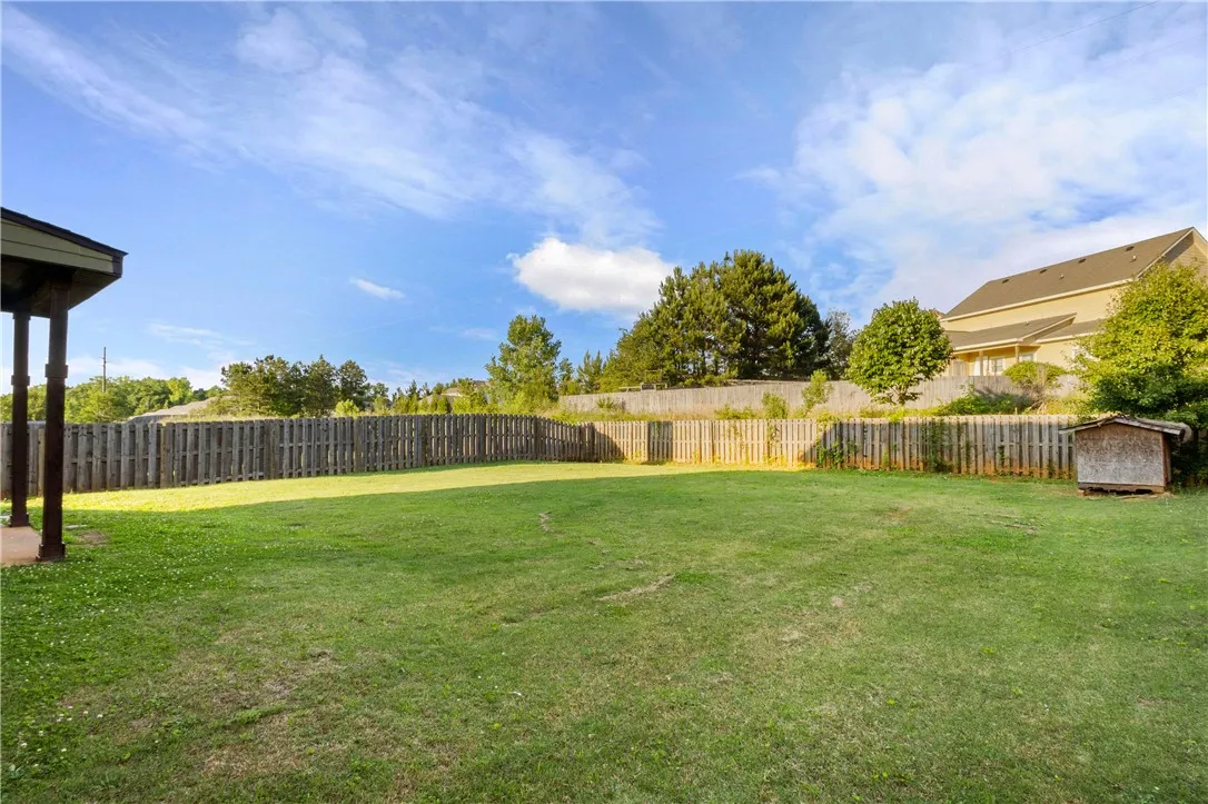 This spacious yard offers a perfect canvas for outdoor living and recreation.