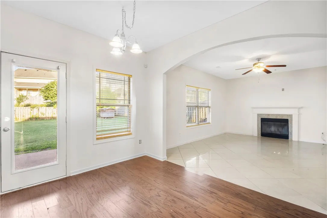 This bright, open space features diverse flooring and a cozy fireplace, perfect for daily living.