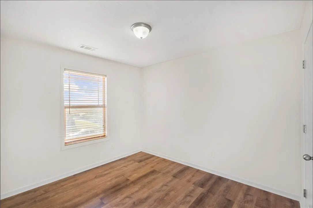 This bright room features LVP flooring and abundant natural light, creating an inviting atmosphere.