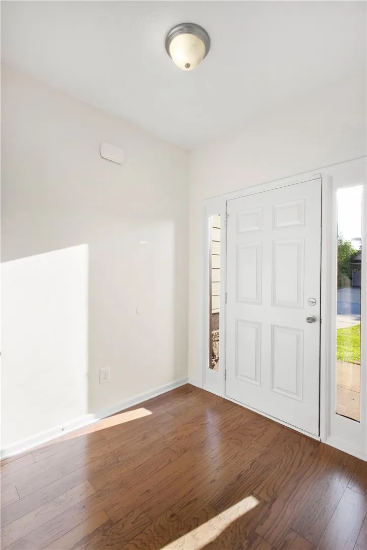 Step into this welcoming entryway featuring warm hardwood floors and abundant natural light.