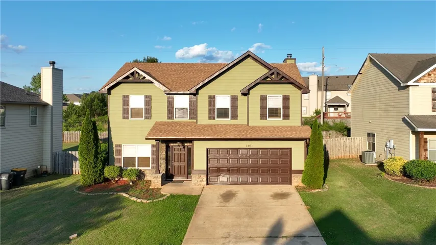 This residence features a good size lawn and a two-car garage, offering comfortable living.