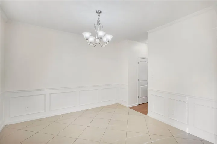 This bright room features tile flooring and detailed wall paneling.