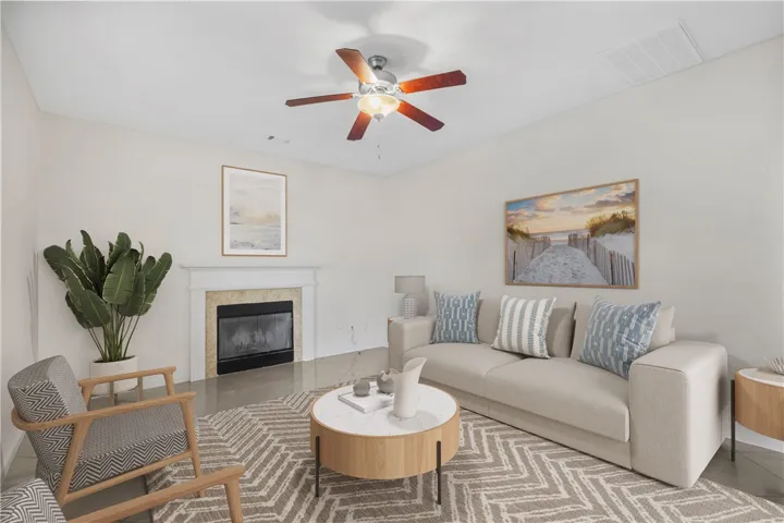 A refined living space features a cozy fireplace with a marble surround, complementing the polished flooring.