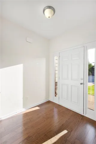 Step into this welcoming entryway featuring warm hardwood floors and abundant natural light.