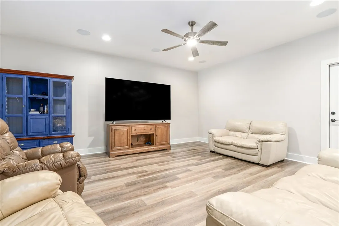 A relaxed living area with ample lighting and durable, stylish flooring, perfect for unwinding.