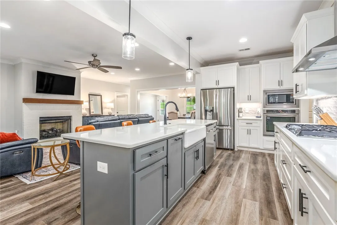 An open concept design seamlessly connects the sleek kitchen to the cozy living area.