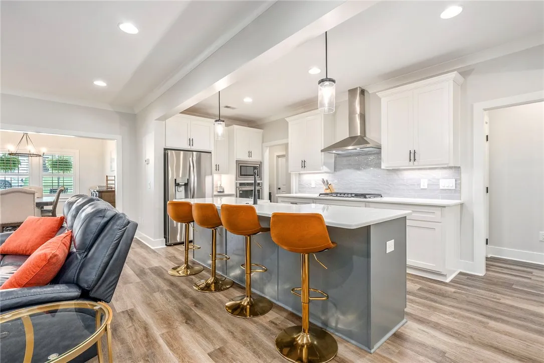A contemporary kitchen design with a functional island and gleaming stainless steel appliances.