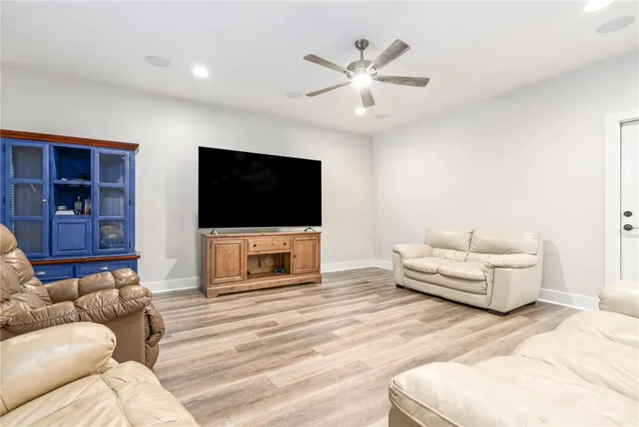 A relaxed living area with ample lighting and durable, stylish flooring, perfect for unwinding.