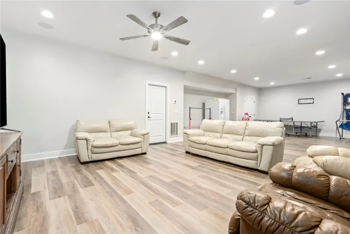 Ample space for recreation and relaxation, this bright basement features durable flooring and a contemporary aesthetic.