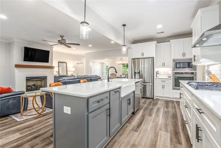 An open concept design seamlessly connects the sleek kitchen to the cozy living area.