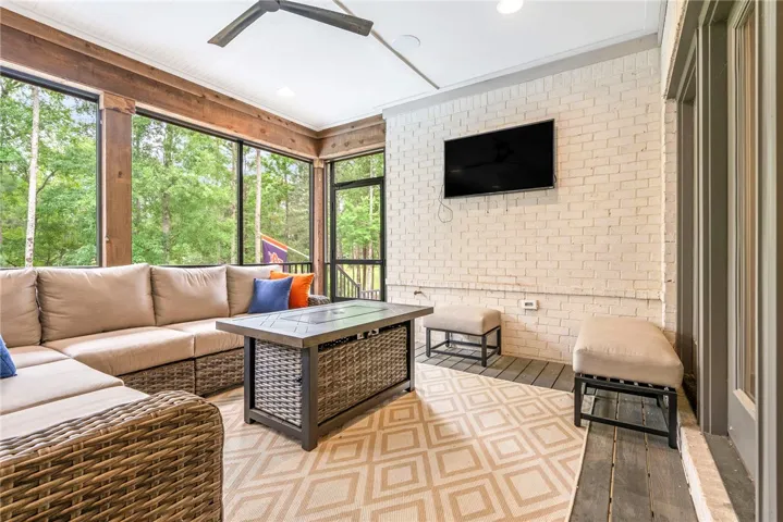 An inviting screened porch offers serene forest views, perfect for unwinding in comfort.