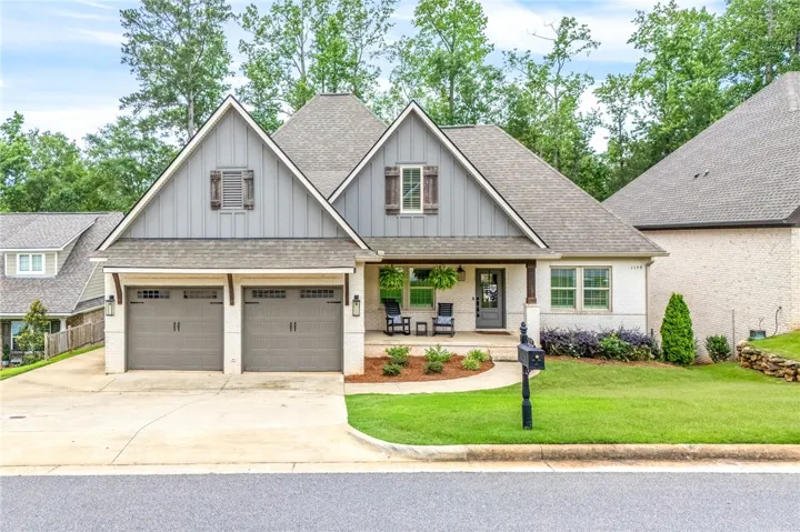 A well-maintained facade with double garages and a welcoming covered porch invites residents home.