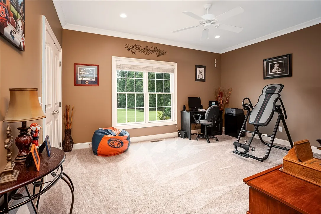 Well-lit room with ample natural light, ideal for a productive home office or exercise space.