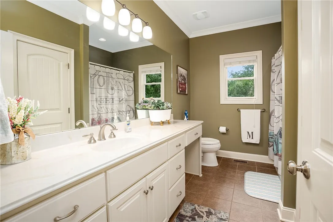 A well-appointed bath boasts ample counter space and a convenient vanity area.